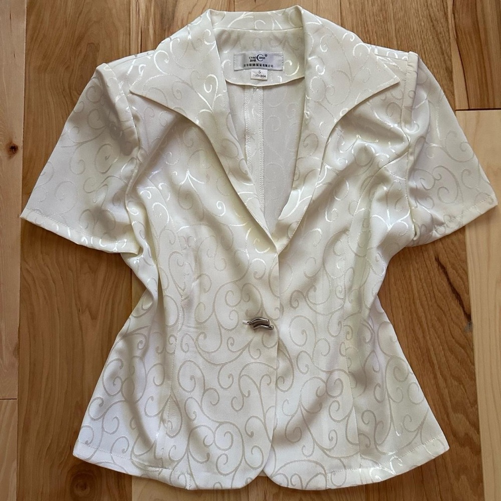 Whimsical white and silver blouse with shiny swirl details